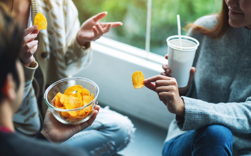 Friends eating potato chips together
